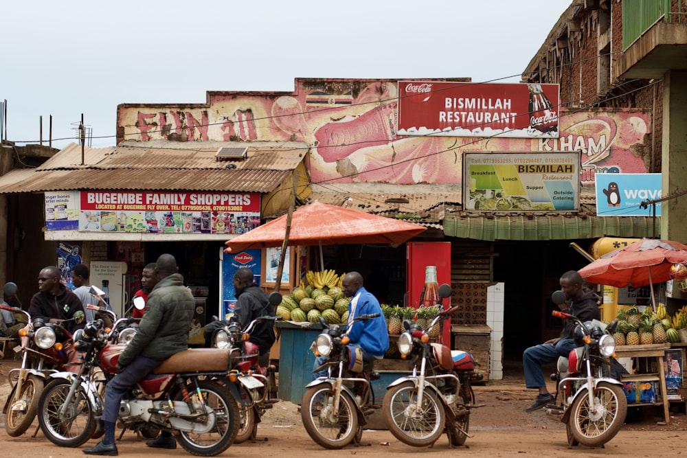 a group of people ride motorcycles down a street