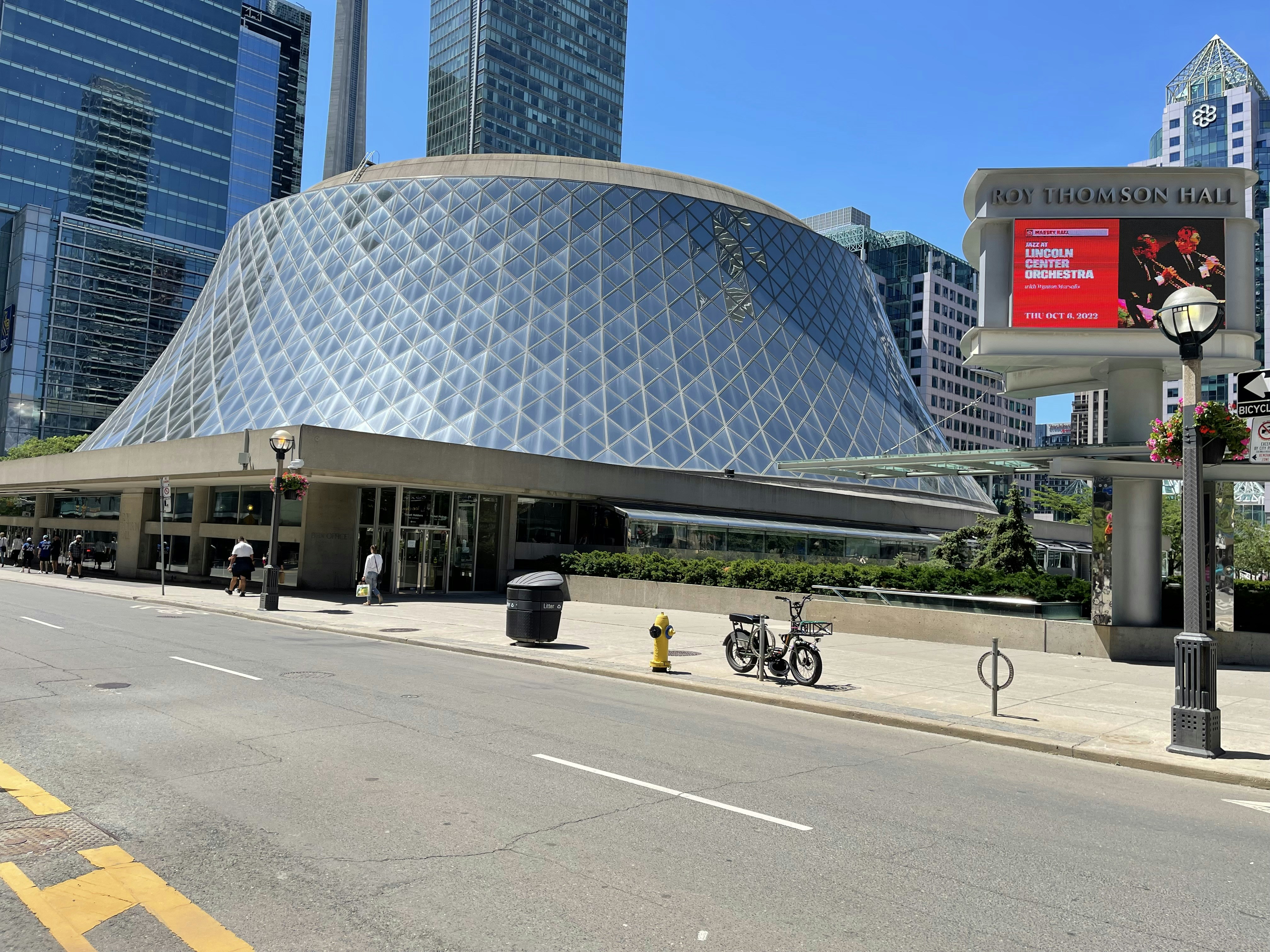 a large building with a bike parked in front of it with Civic Arena in the background, 