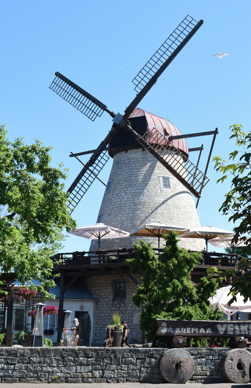 a windmill with a building in the background