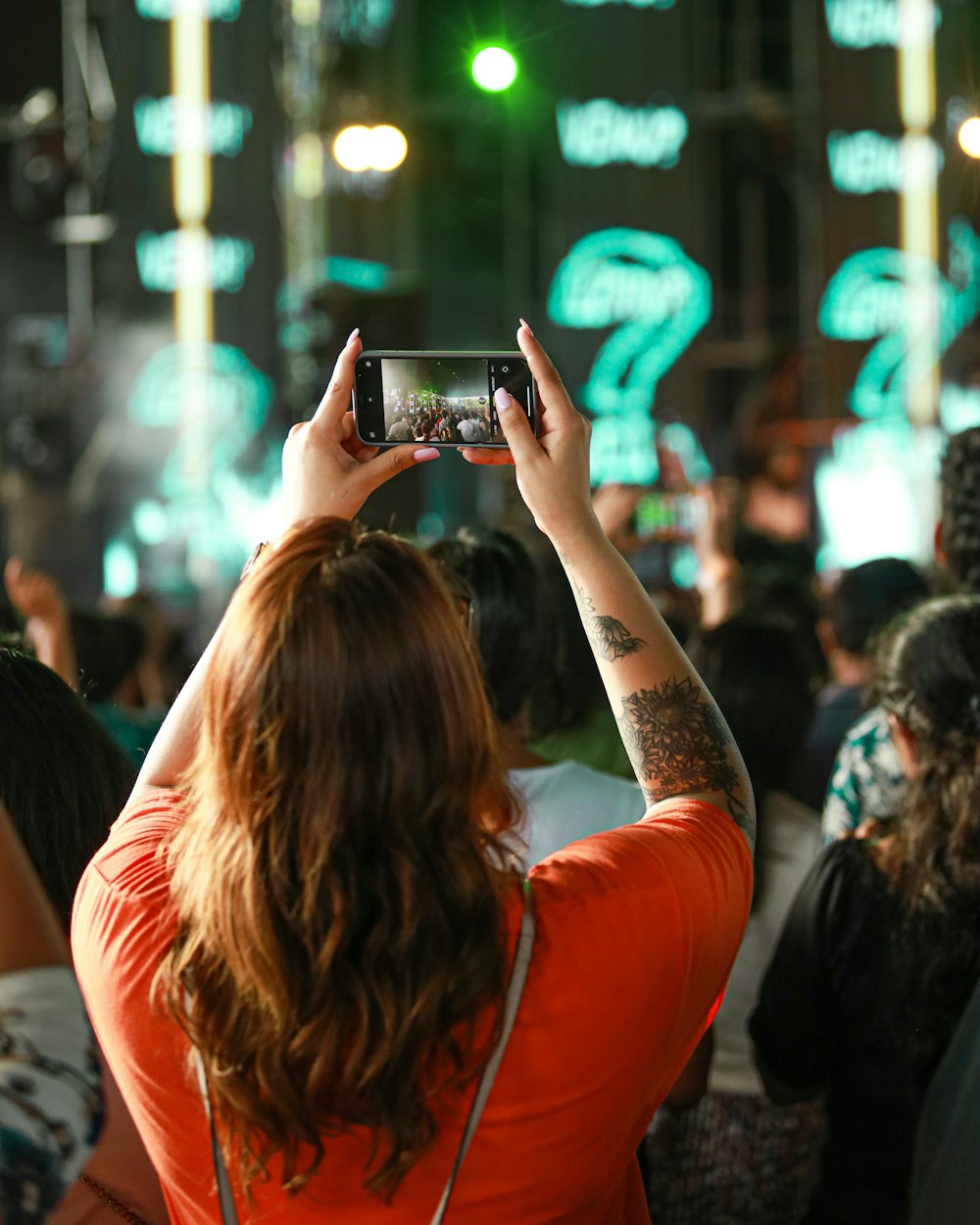 a person taking a picture of a crowd