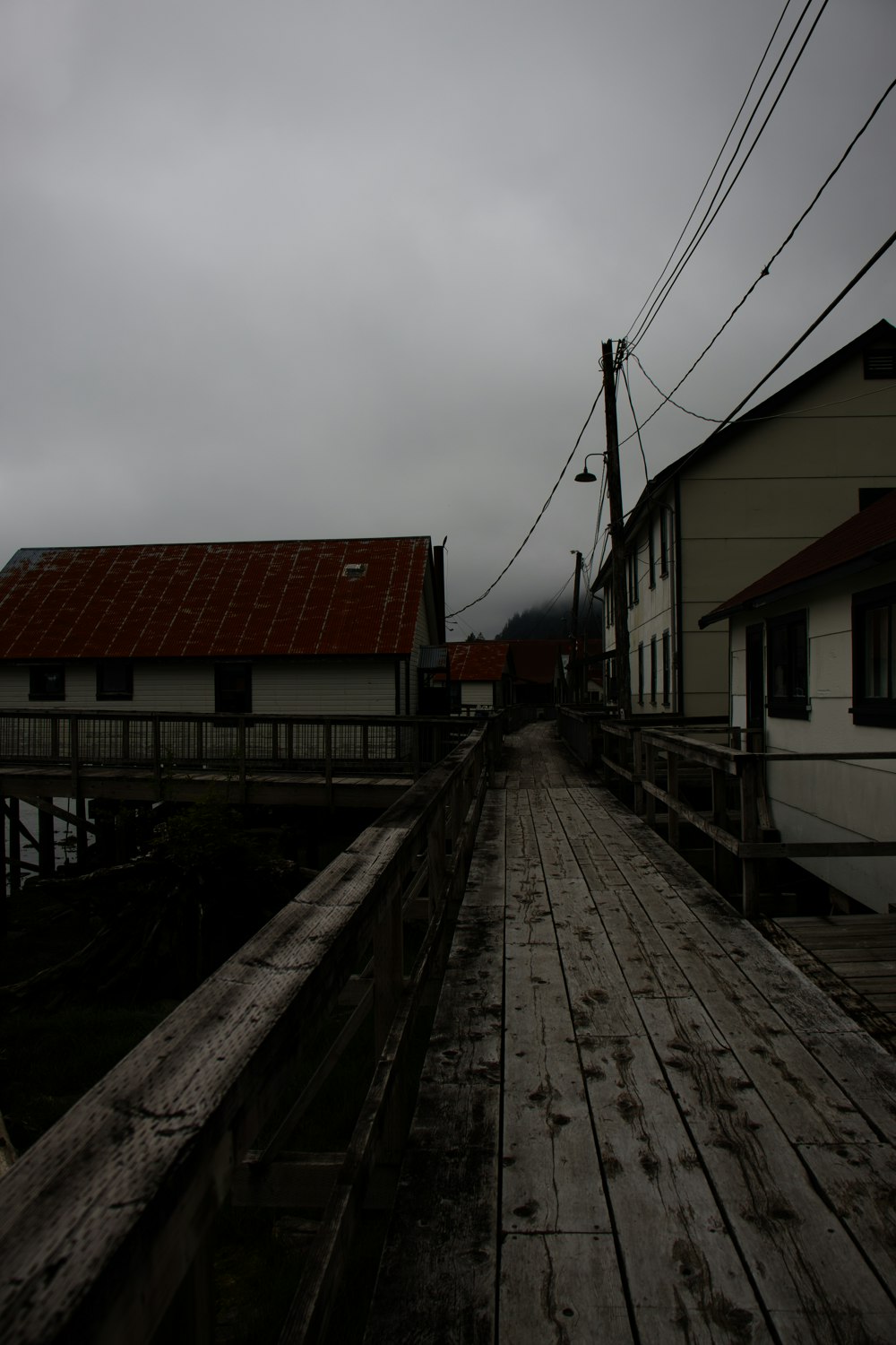 a wooden bridge with buildings on either side of it