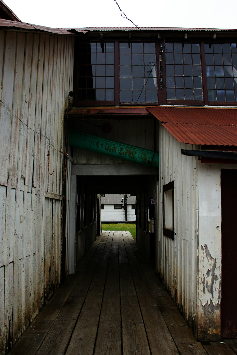 a wooden walkway between two buildings