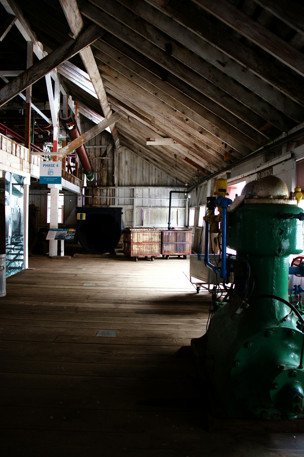 a large warehouse with a green tractor