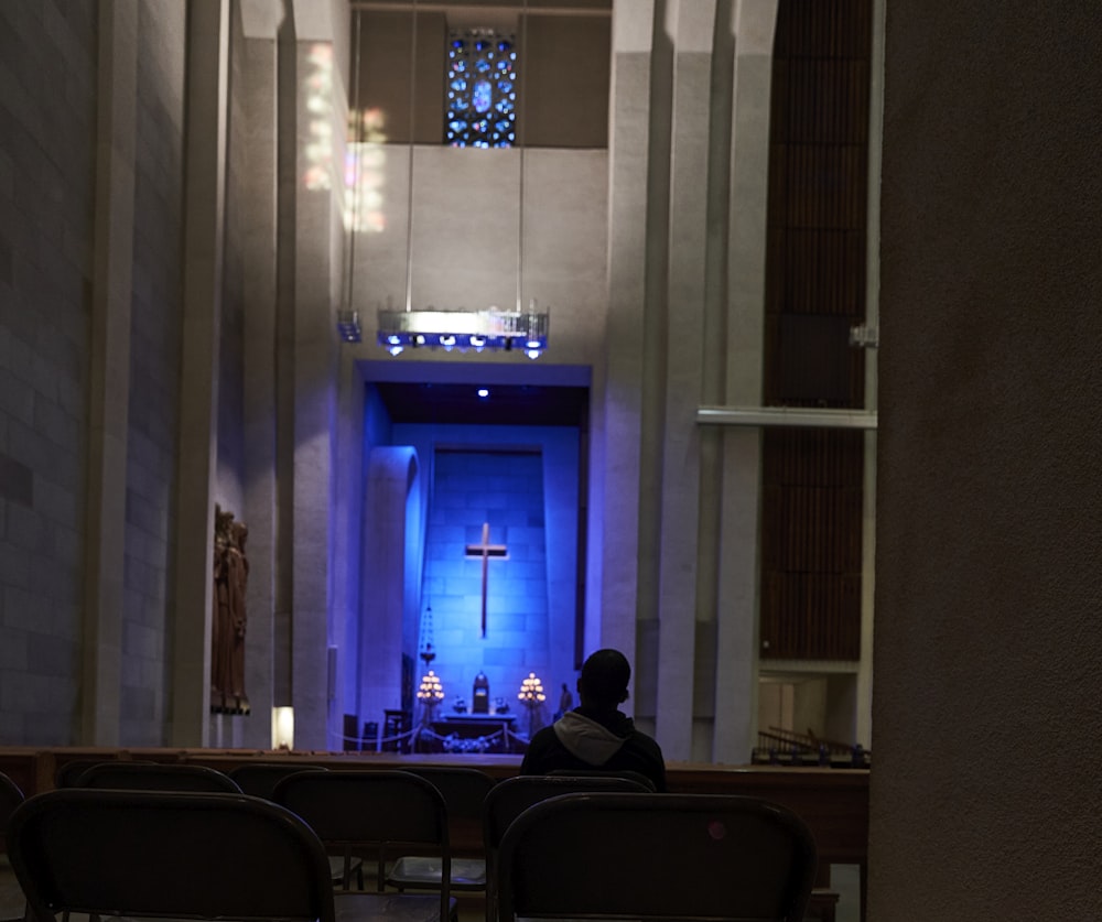 a person sitting at a desk in a church