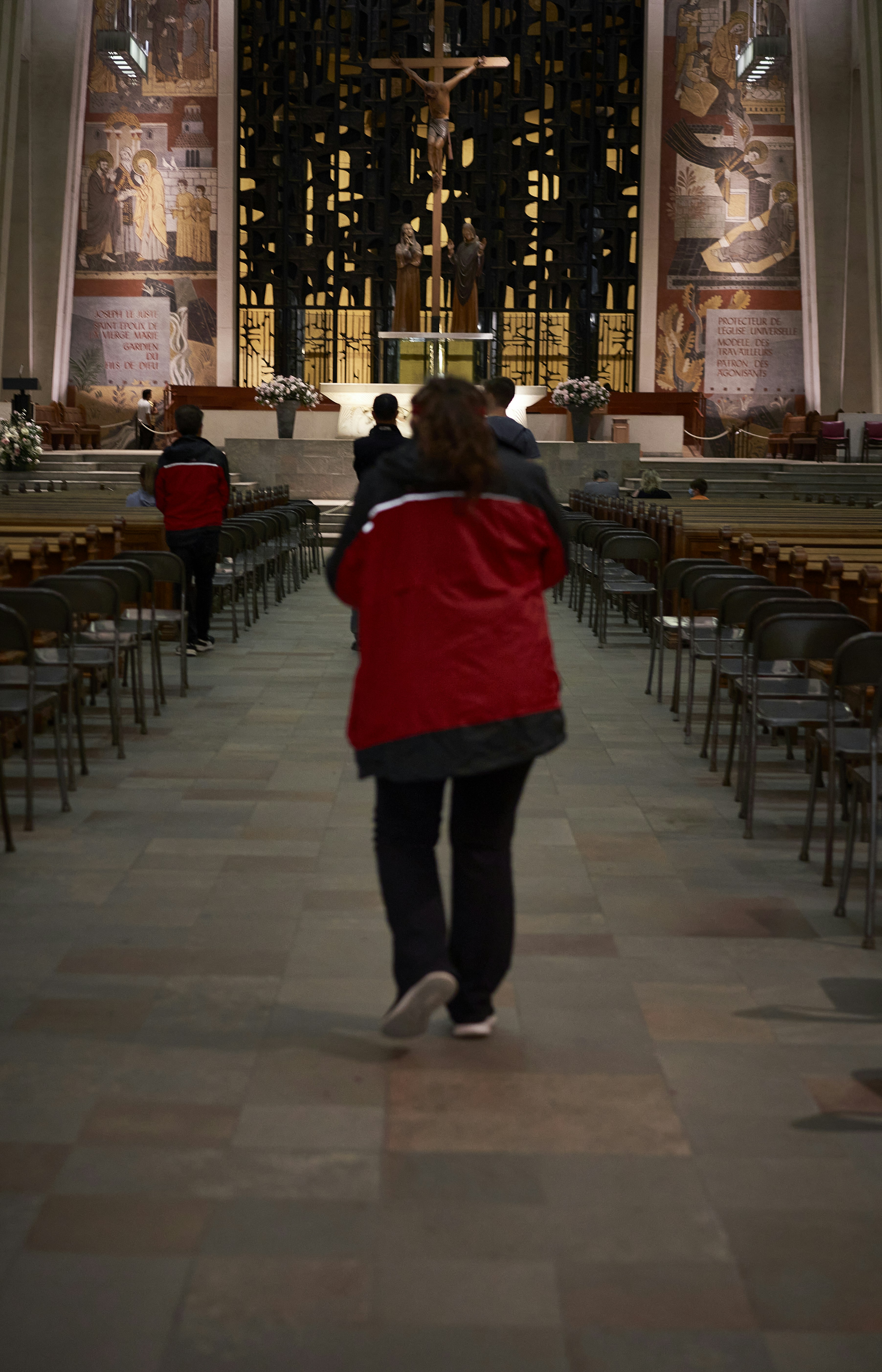 a person walking in a large room with tables and chairs