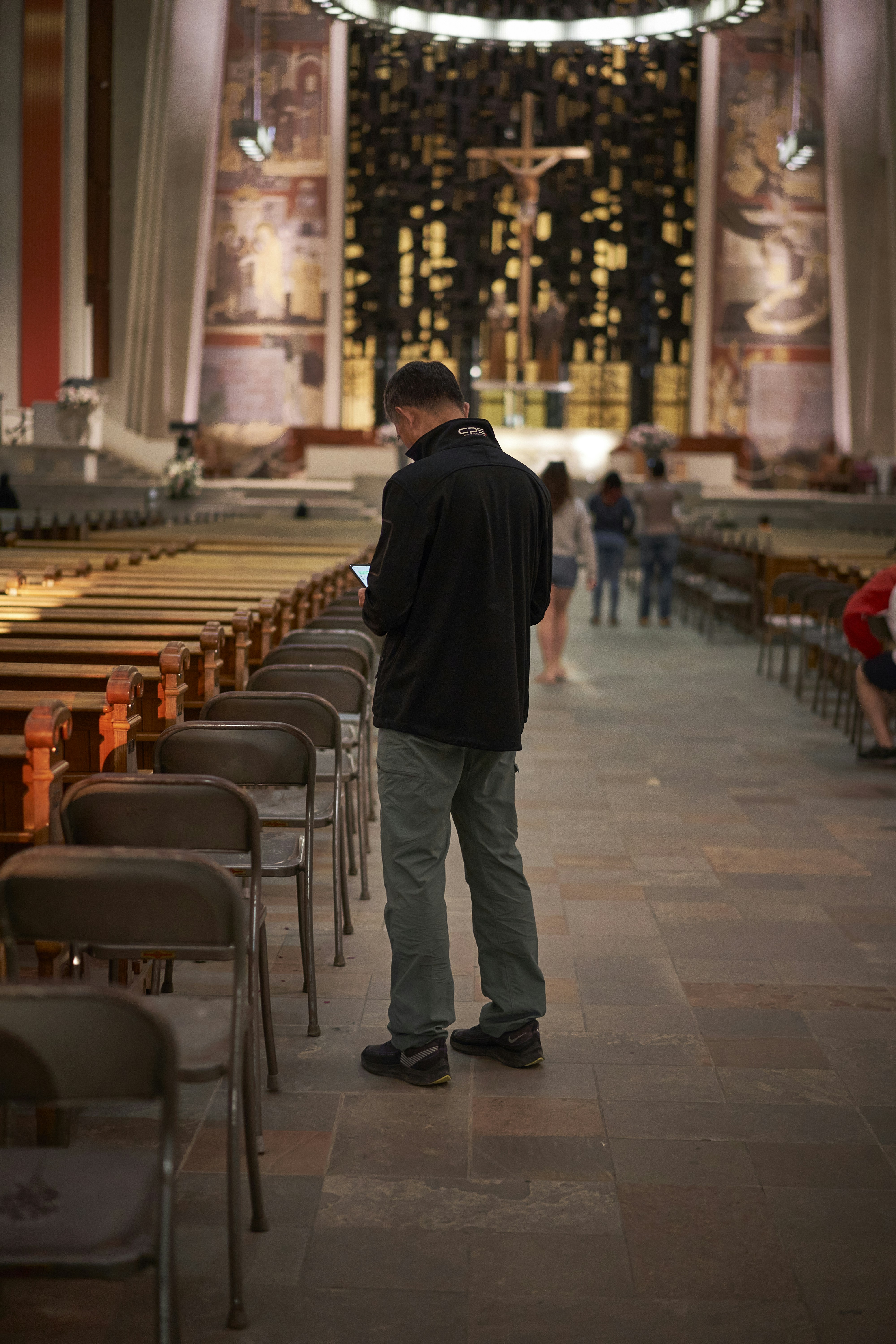 a man standing in a room with chairs and tables