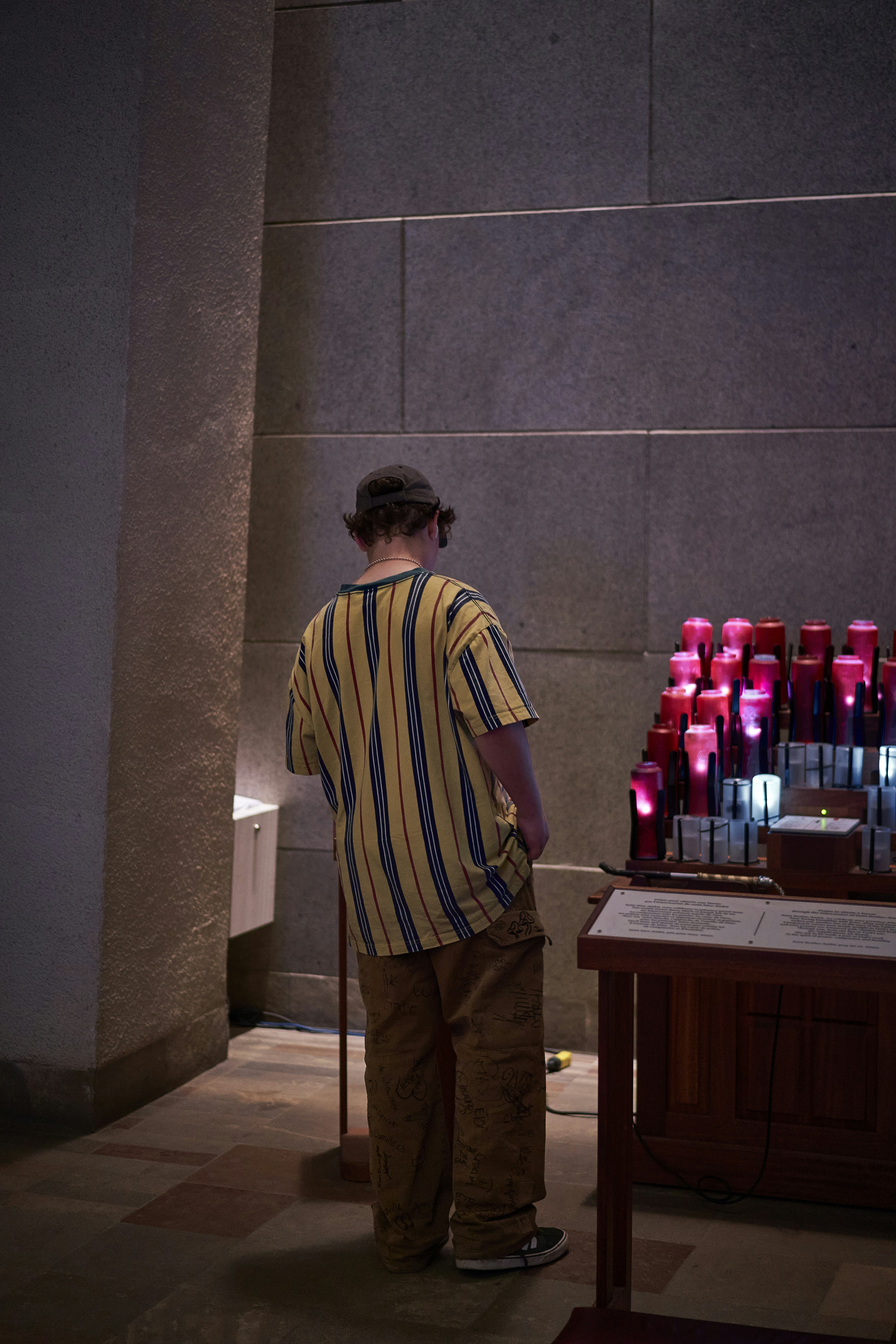 a man standing in front of a display of bottles