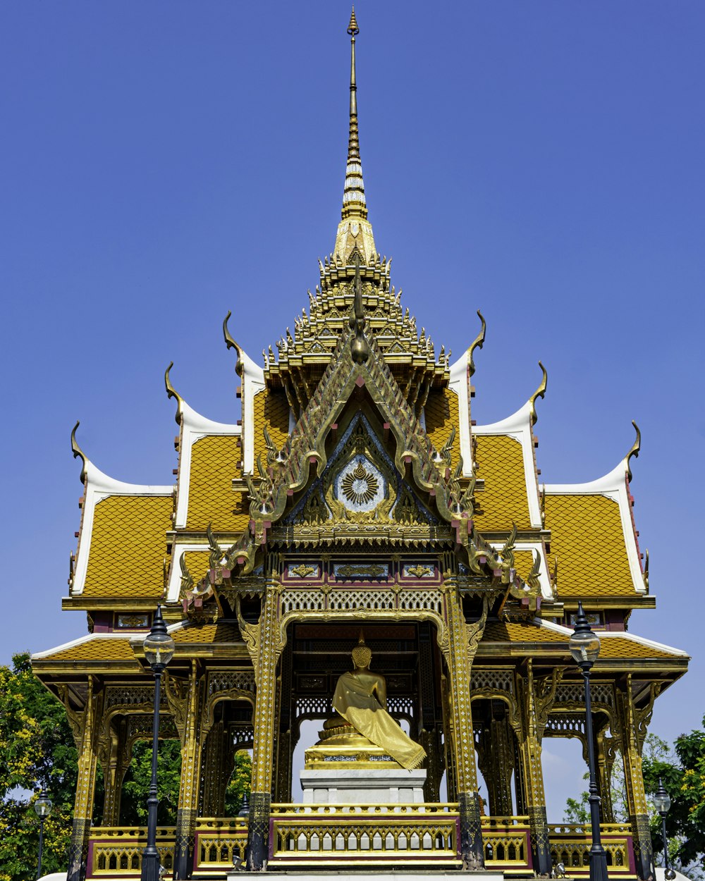 a large ornate building with a gold statue in front of it