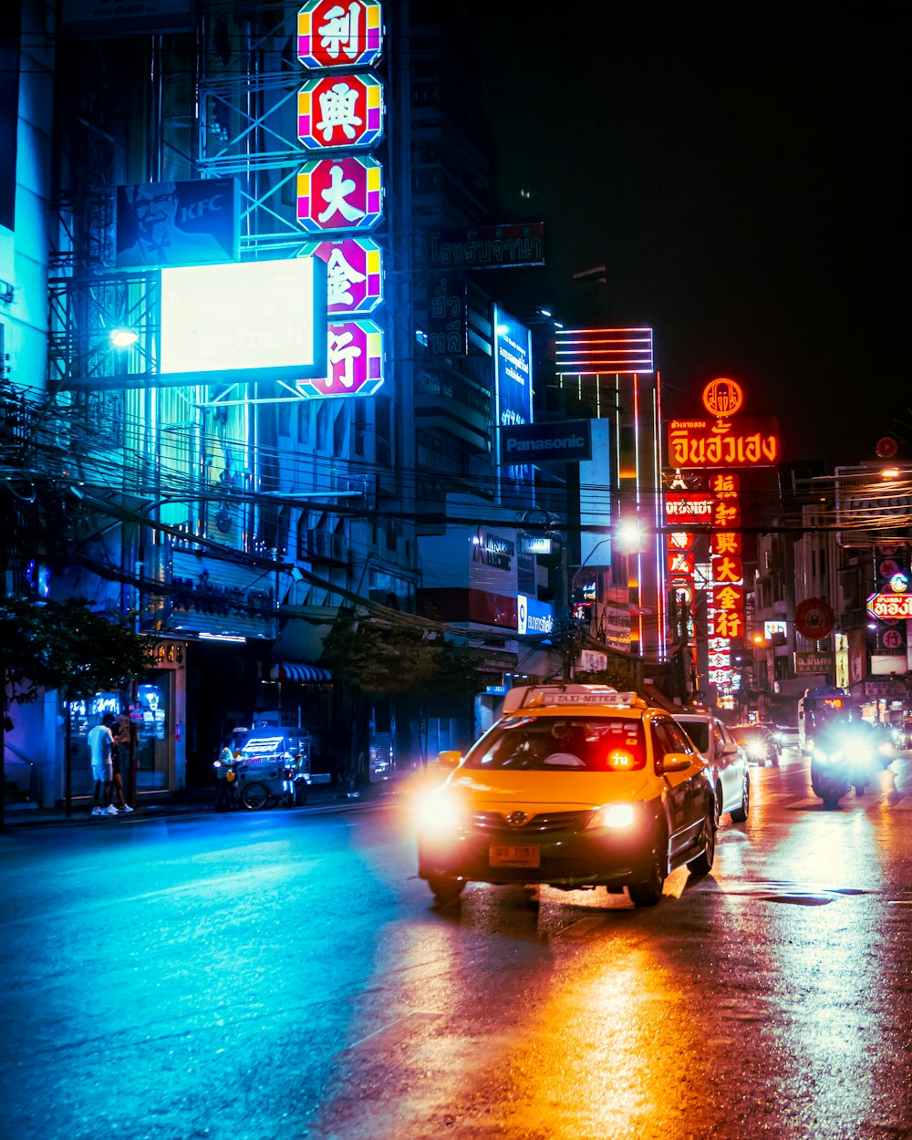 a taxi driving through a city