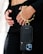 A person is holding a sleek black phone case with a gold metallic wristlet attached. The focus is on the elegant accessory, which contrasts against a black outfit. The person's hands are gently positioned near the waist, adding to the sophisticated appearance.