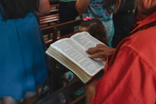 a group of people reading a book