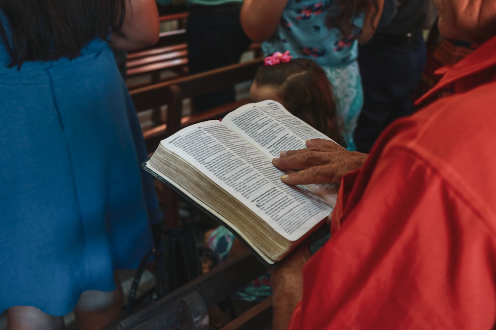 a group of people reading a book