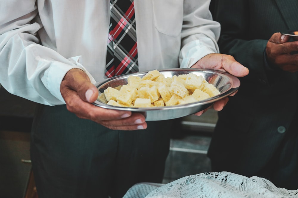 a person holding a bowl of food