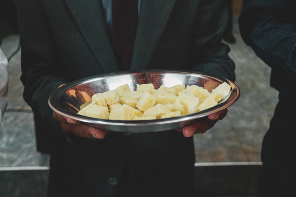 a person holding a bowl of food