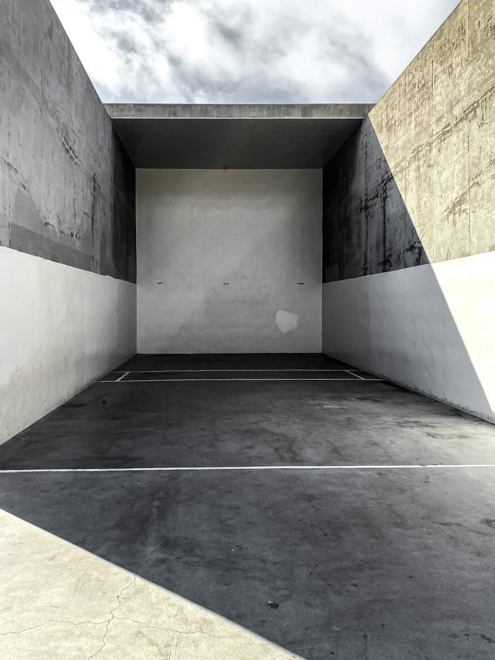 a concrete hallway with a grey wall