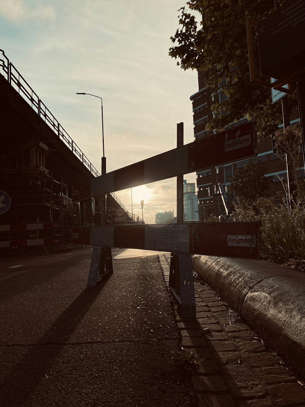 a sidewalk with a railing and buildings