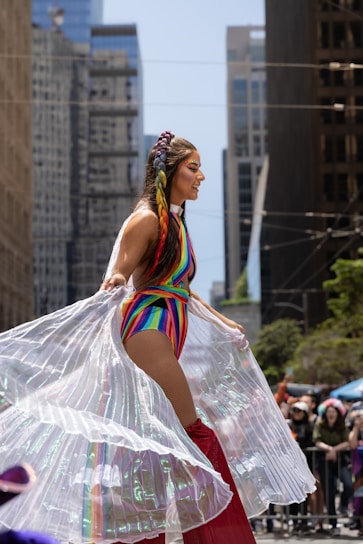 A vibrant city street scene with a model wearing Rainbow Collections' latest trendy outfit, capturing urban energy.