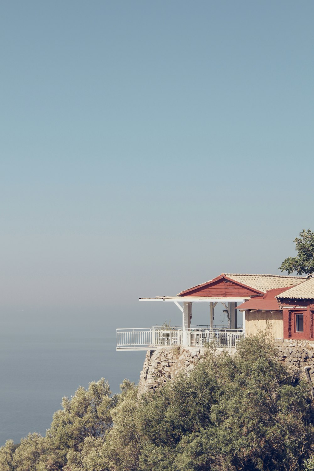 a building with a red roof surrounded by trees