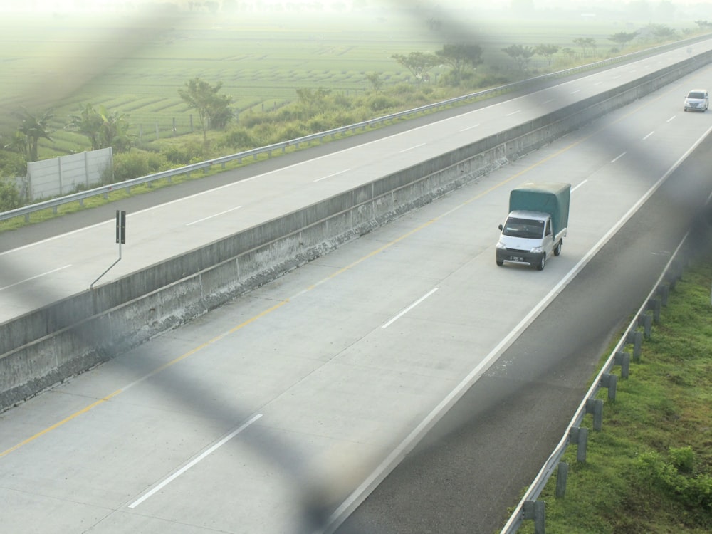 a group of cars driving on a highway