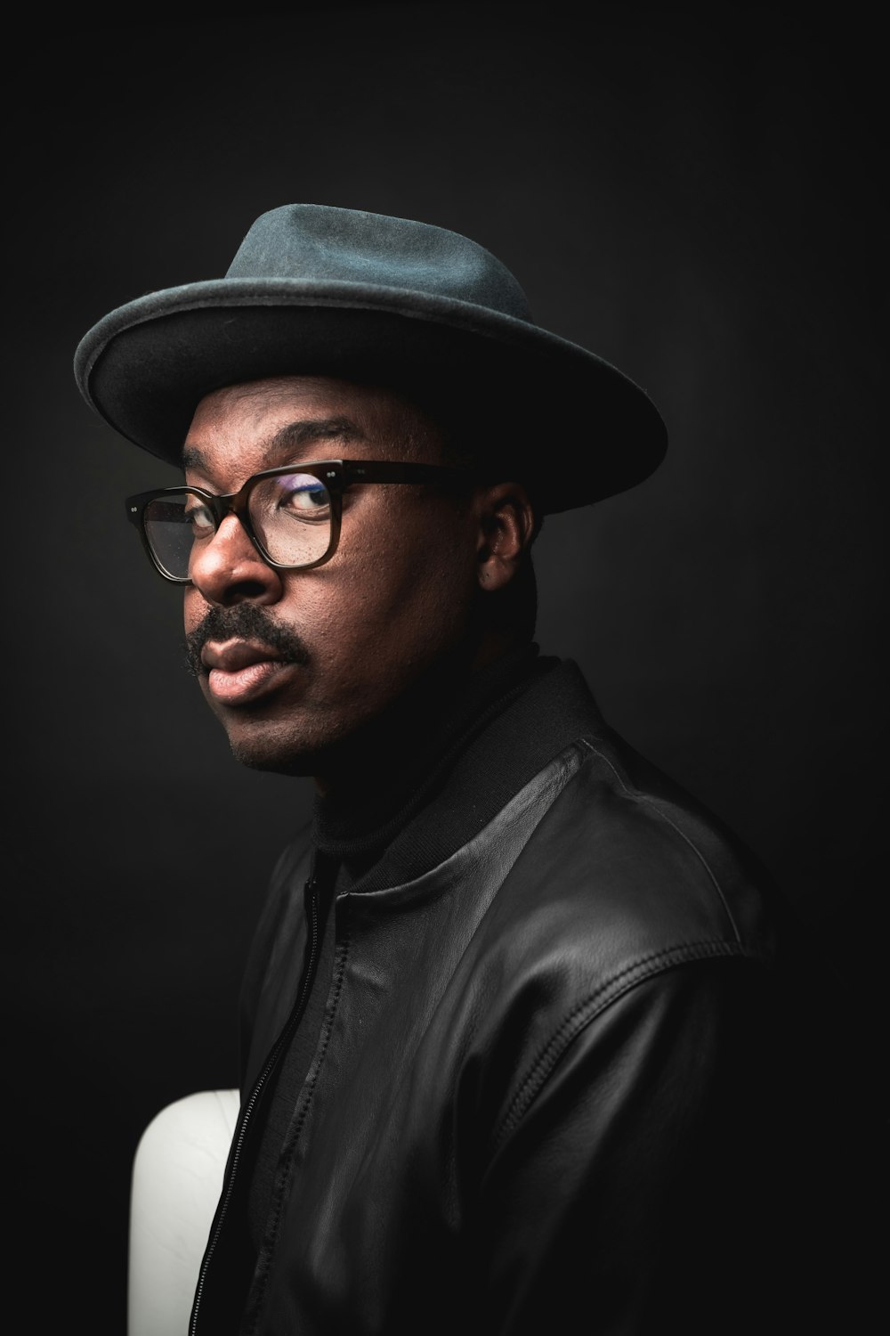 a man wearing a hat and glasses