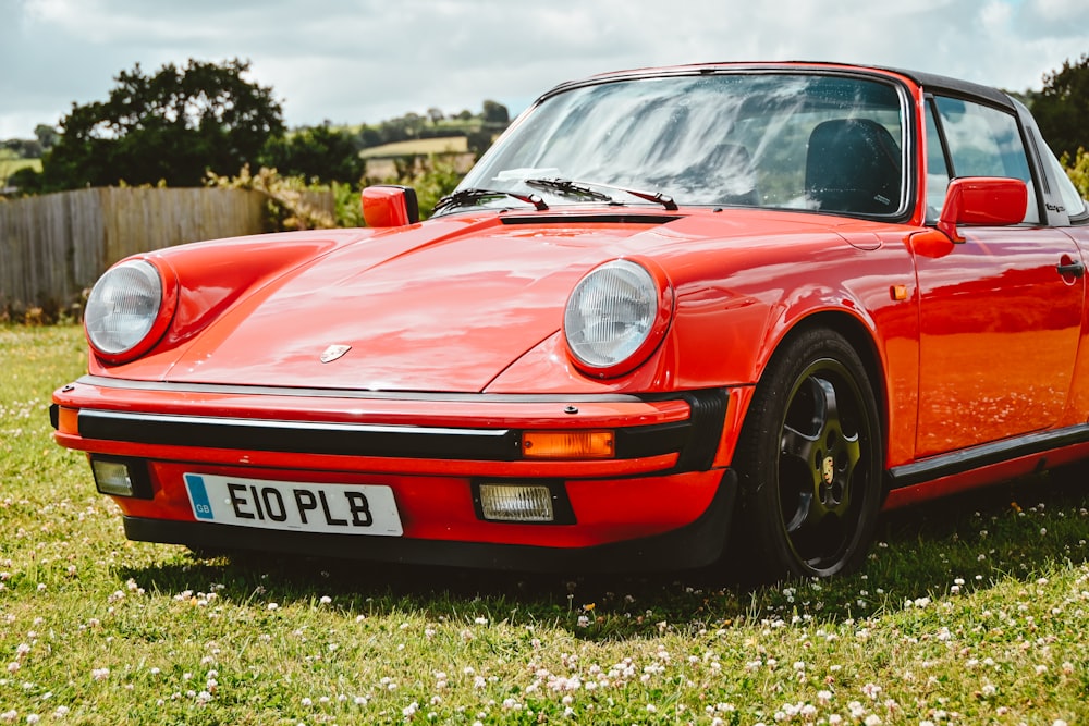 a red car parked on grass