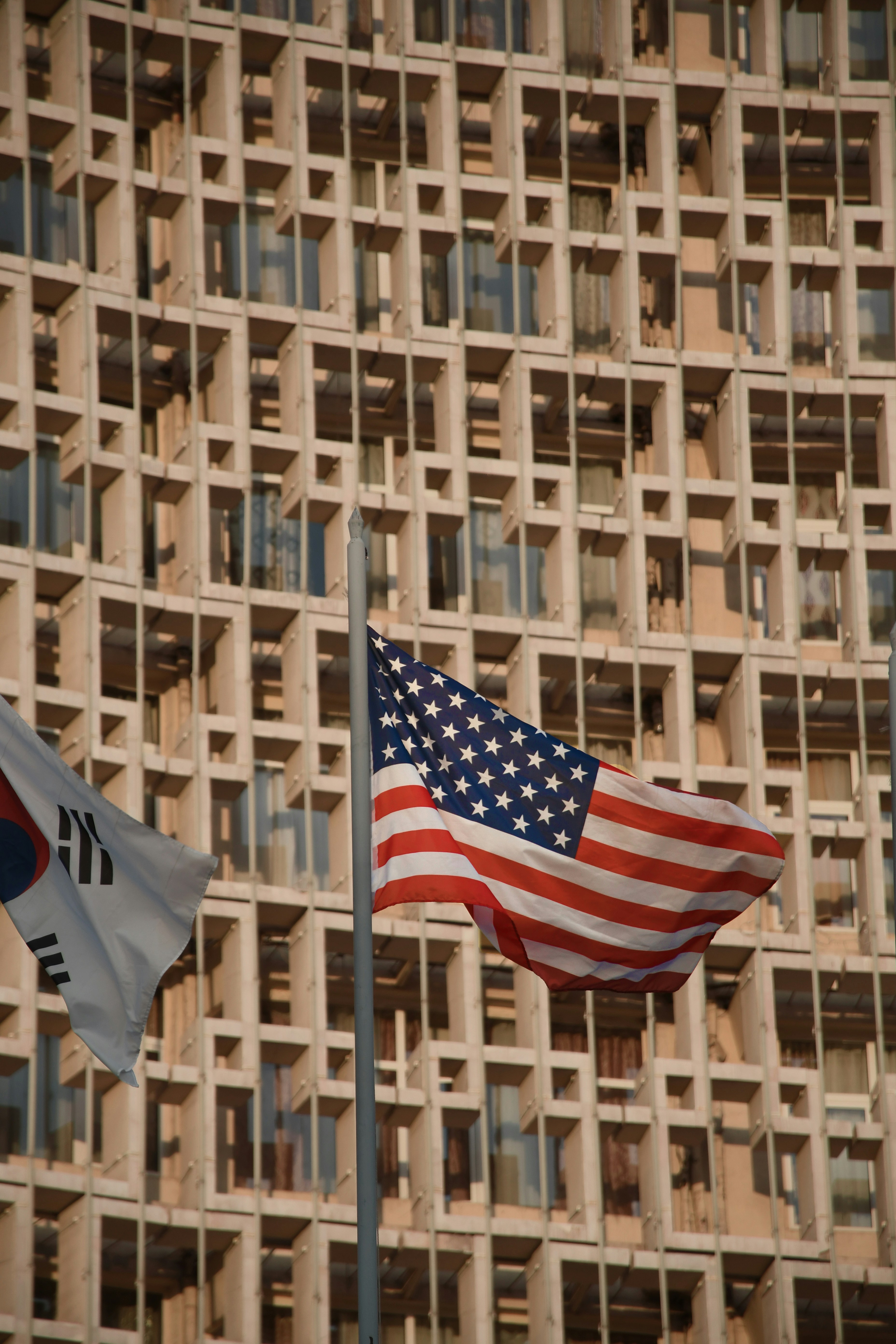 a few flags in front of a building