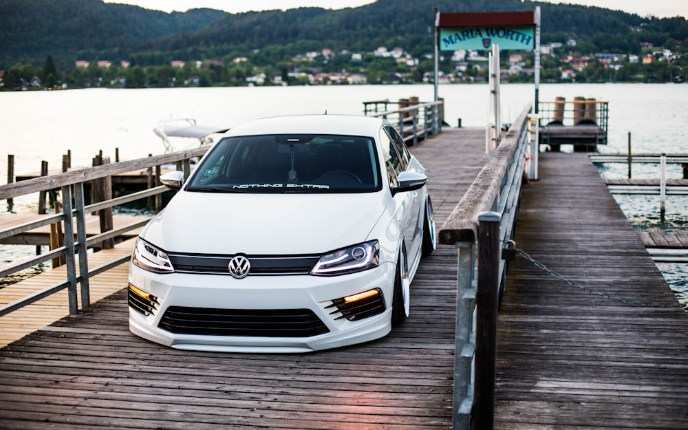 a white car parked on a dock