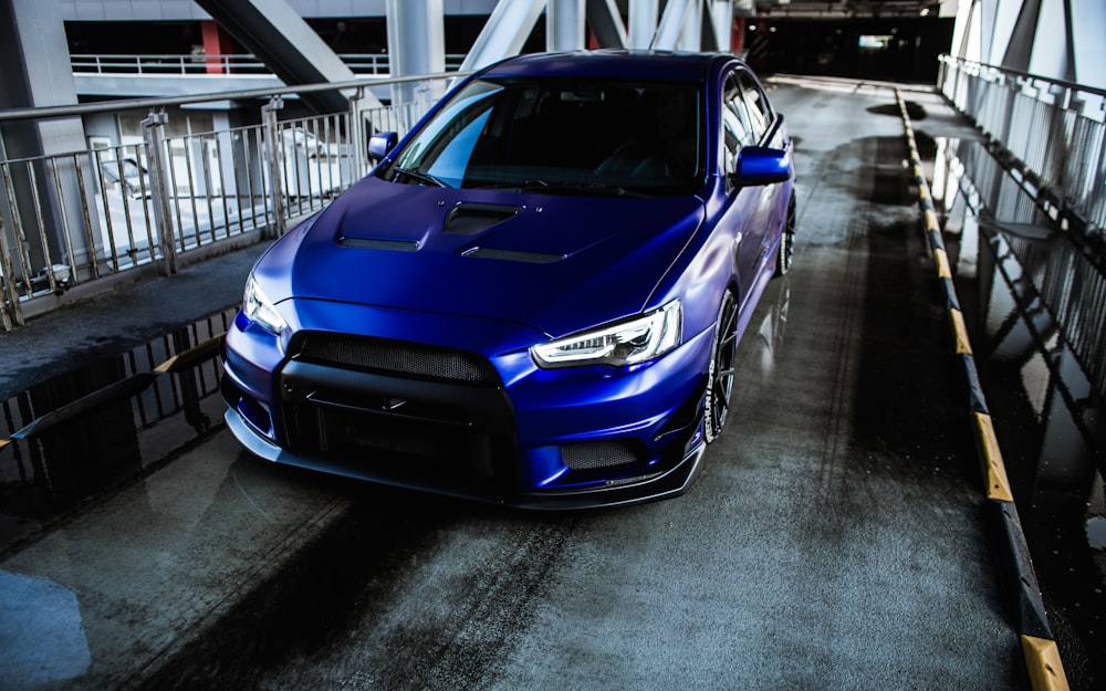 a blue car parked on a road