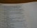 A close-up of an open book displaying a passage from the Bible. The text is printed in black ink on white paper, with some lines highlighted in bold. A dotted line is visible on the right side of the page.