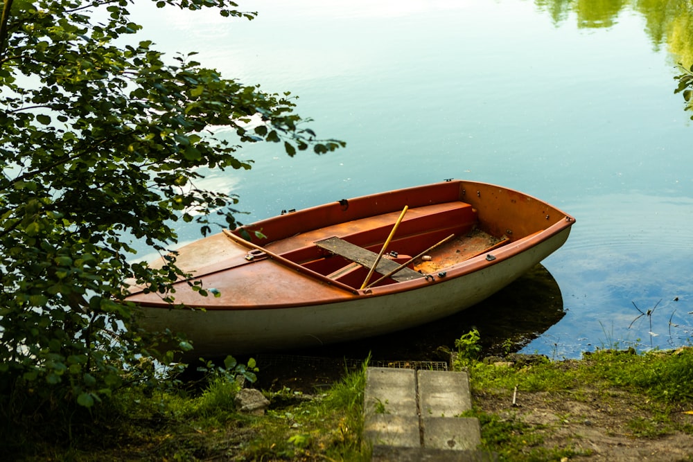 a boat sits on the side of a river