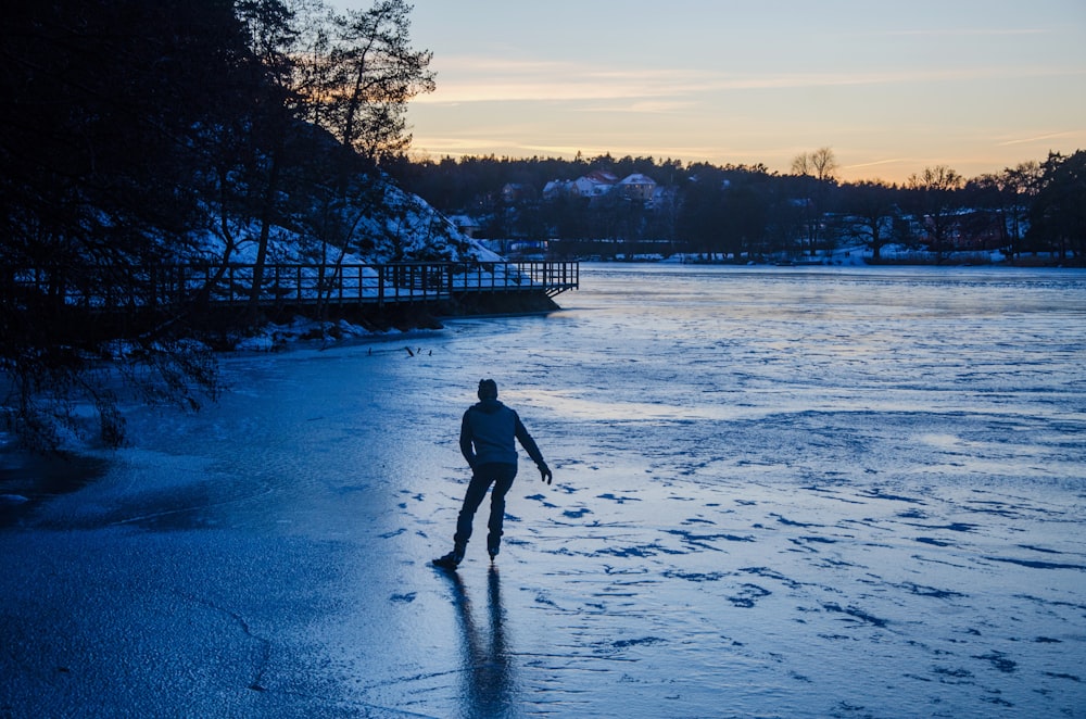 a person walking on a frozen lake