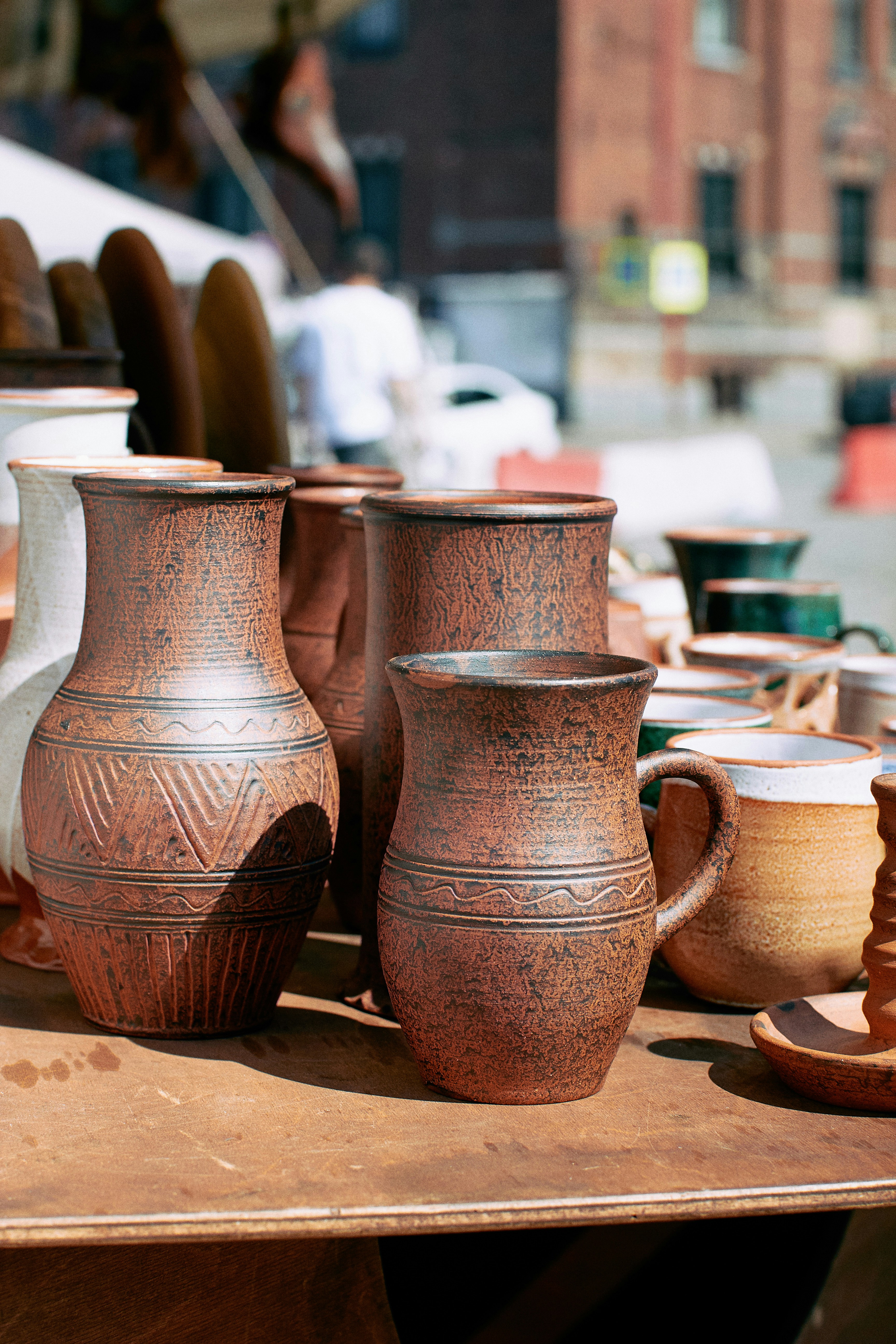 A group of pottery pots photo Free Person Image on Unsplash