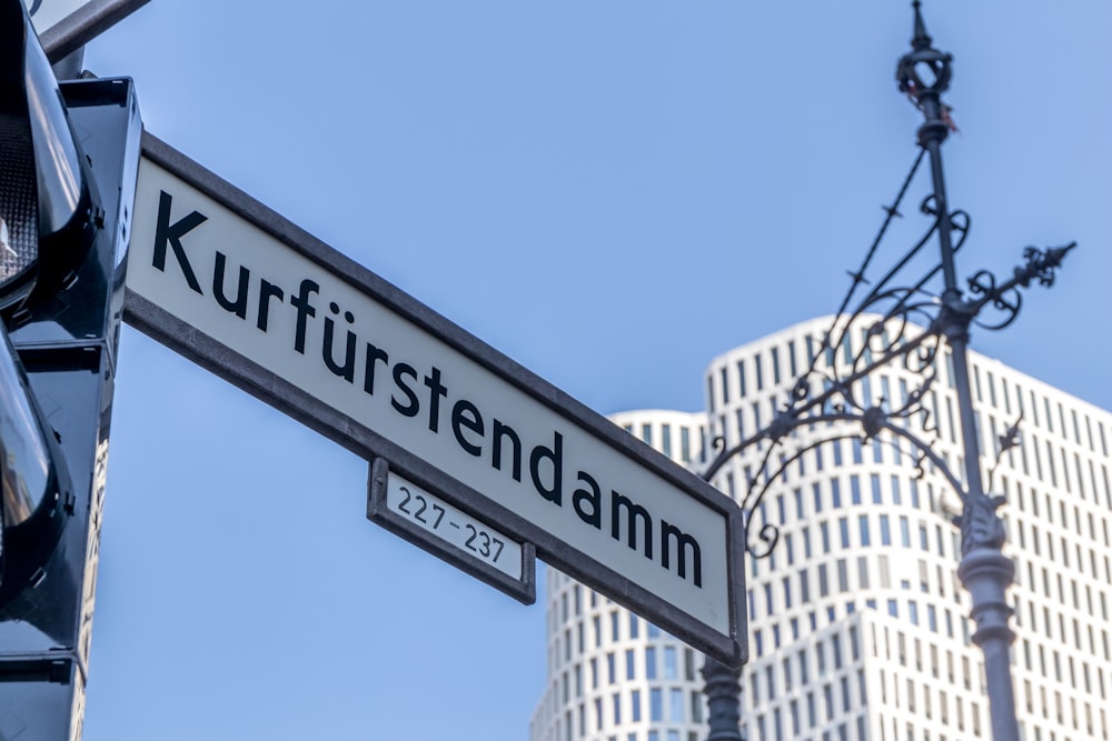 a close up of a street sign hanging from a pole