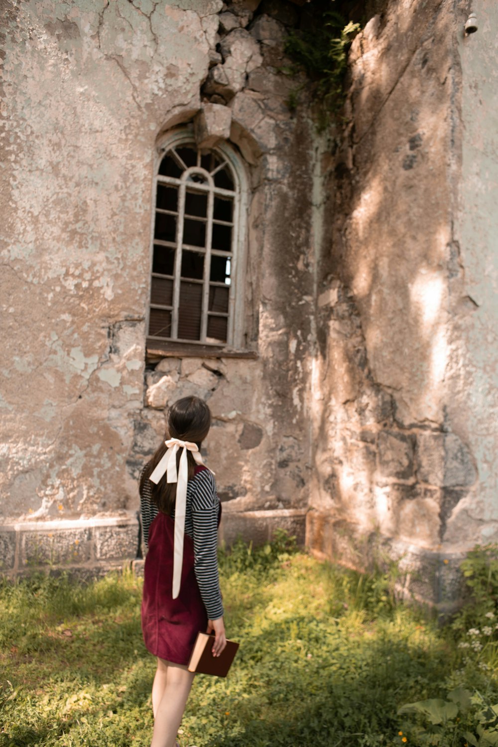 a person standing in front of a stone building