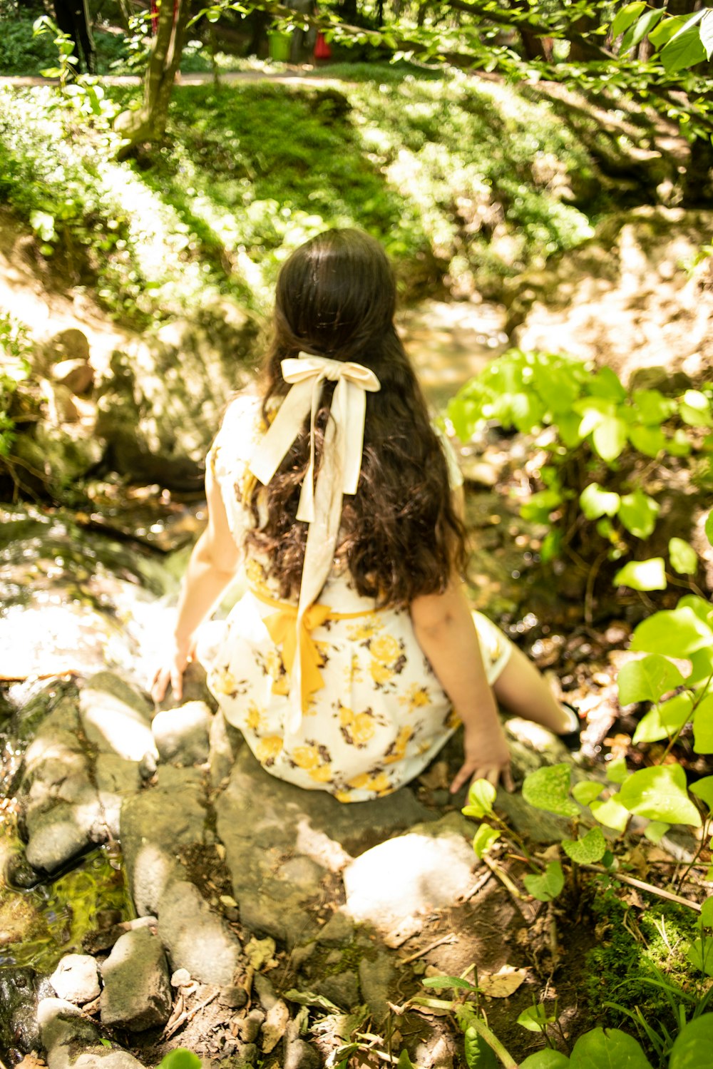 a girl sitting on a rock