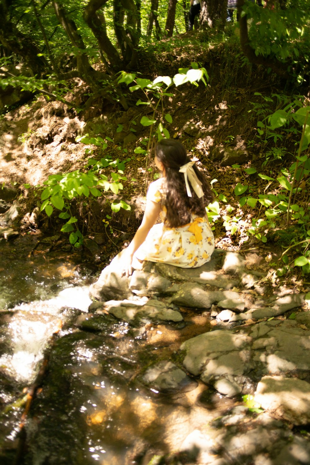 a person sitting in a stream