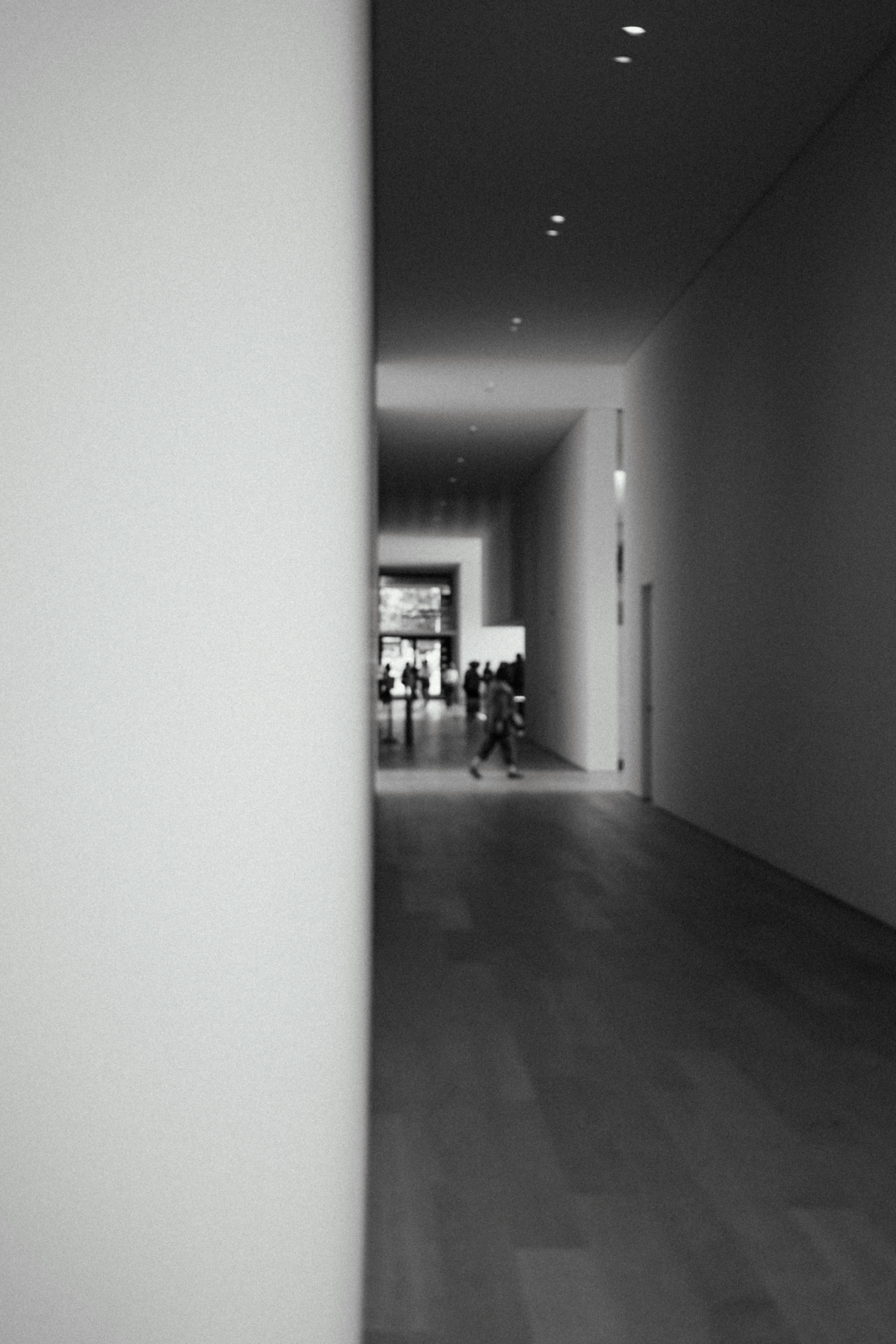 a group of people walking through a hallway