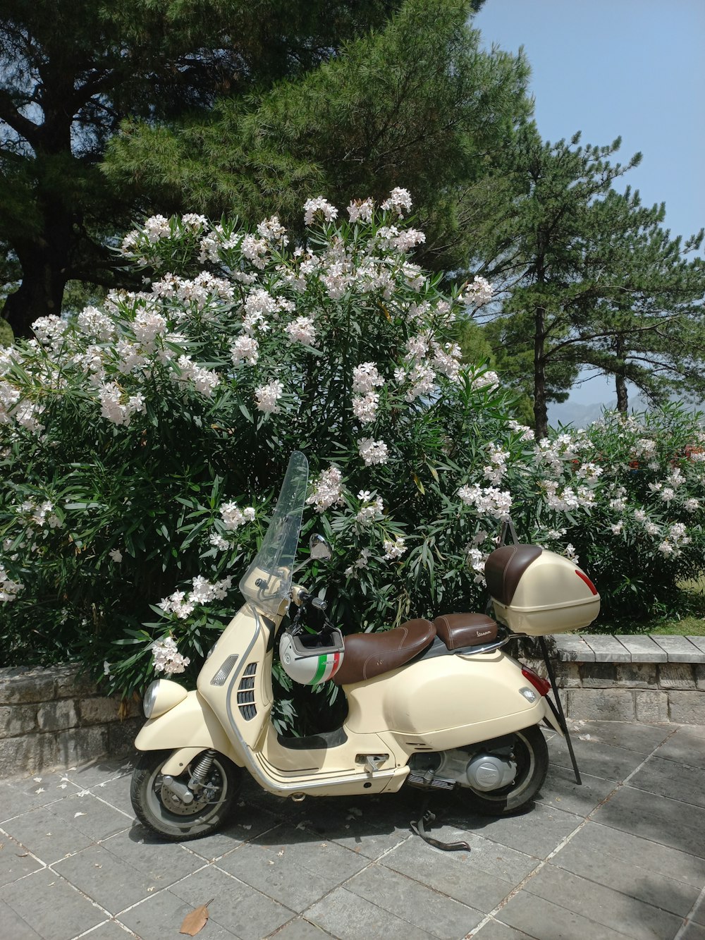 a moped parked on a sidewalk