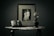 A vintage-style setting featuring an old photograph in a frame showing a couple, alongside a film camera and an antique oil lamp placed on a decorative table.