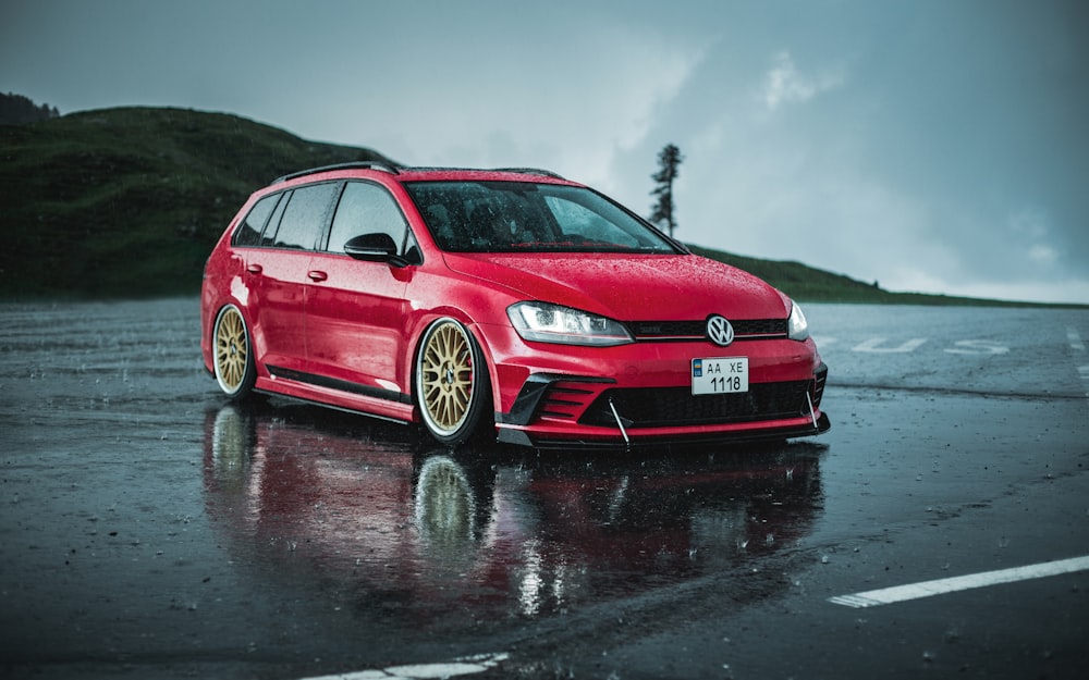 a red car on a wet road