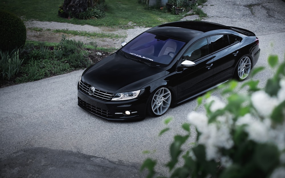 a black car parked on a driveway