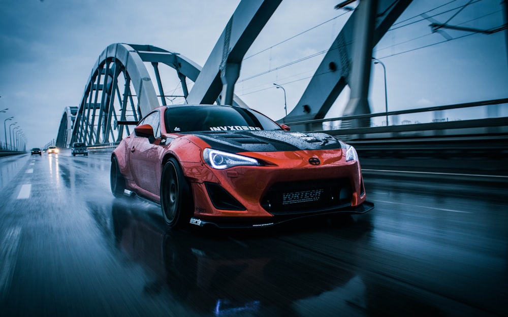 a red sports car on a bridge