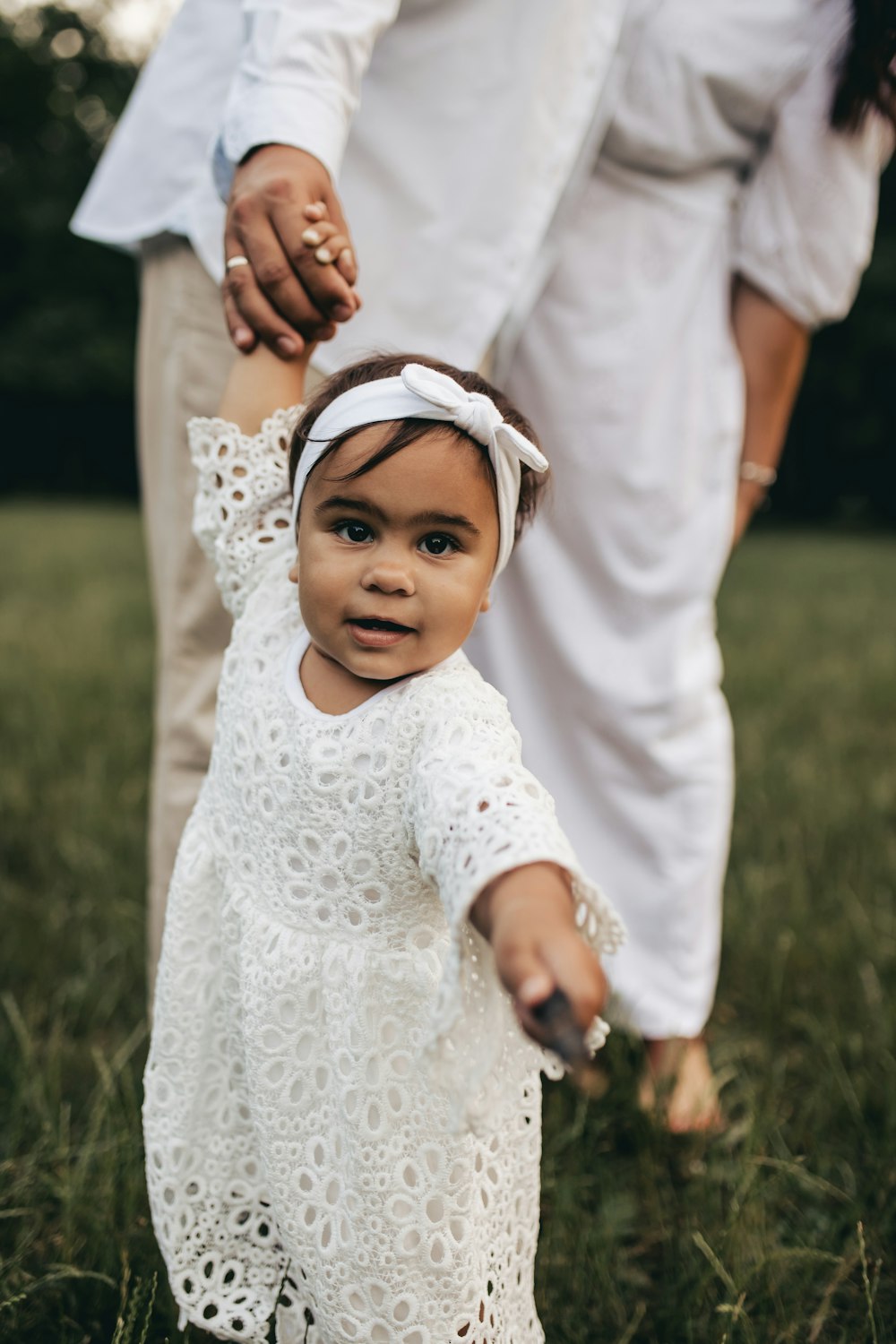 a baby girl in a white dress