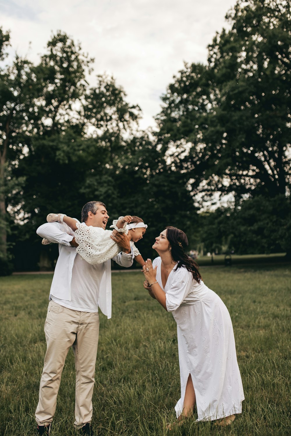 a man and woman holding a baby