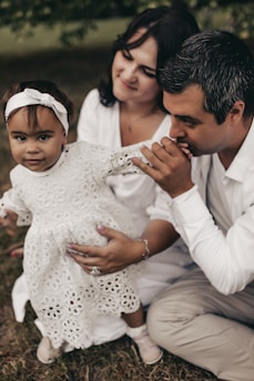 Hands gently laid on a child’s head during a tender blessing ceremony in a cozy chapel.