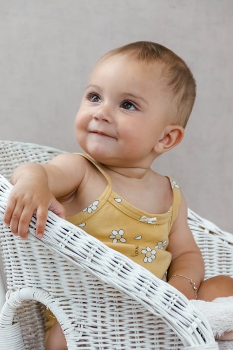 a baby in a yellow dress
