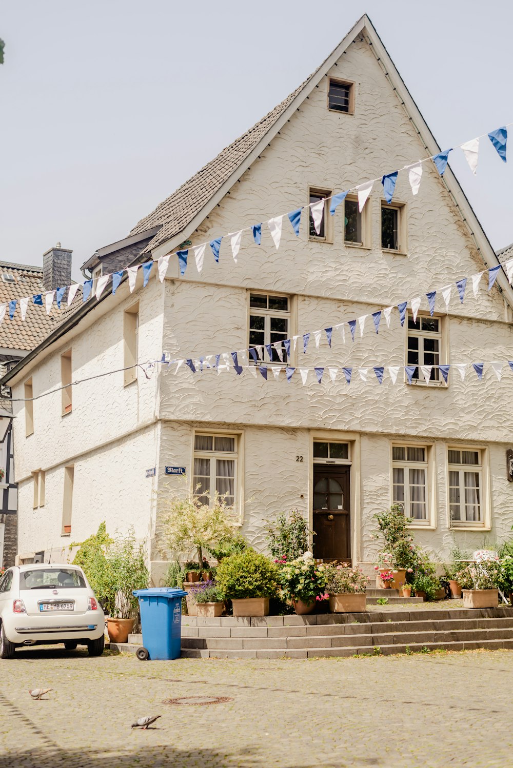 a white building with blue flags