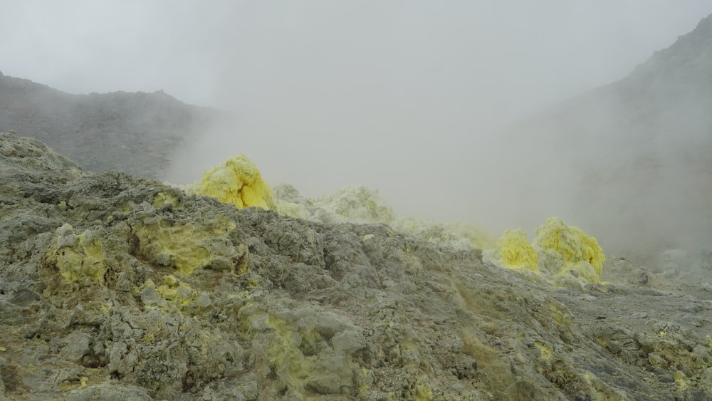 a rocky hillside with fog