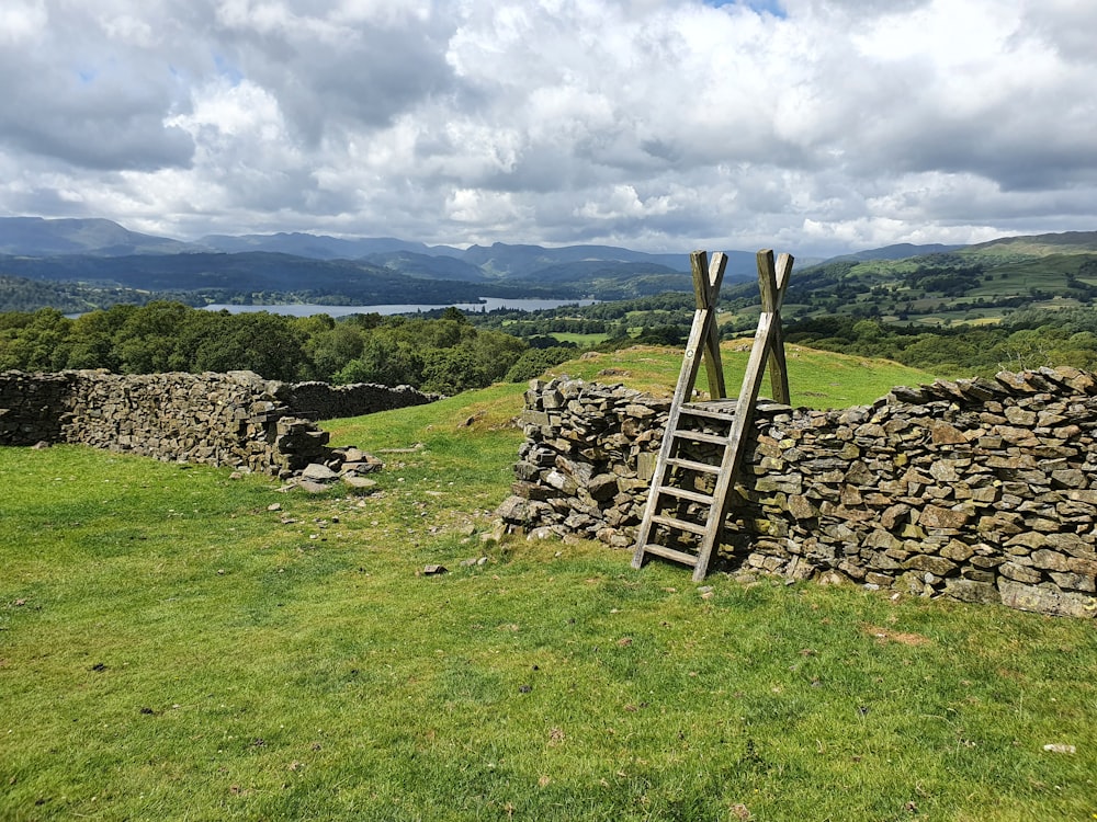 a stone structure in a grassy field