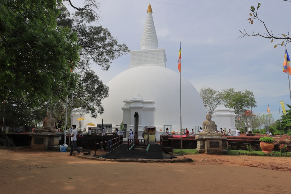 a white building with a dome and a flag in front of it